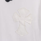 White T-shirt close-up of white-on-white cross applique with stitched outline