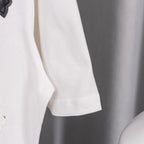 White T-shirt sleeve hem detail with visible seam stitching