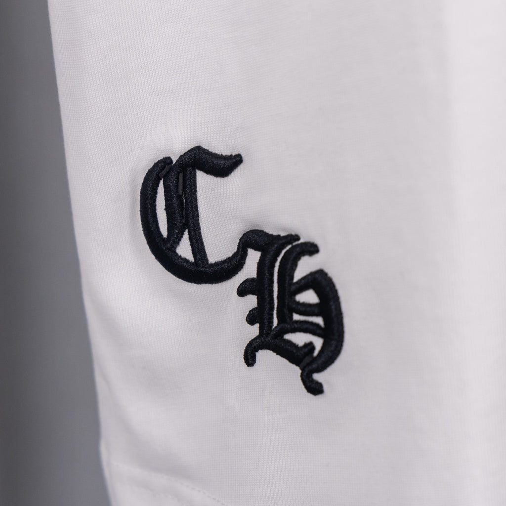 White T-shirt close-up of black monogram-style graphic