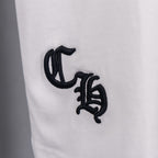White T-shirt close-up of black monogram-style graphic
