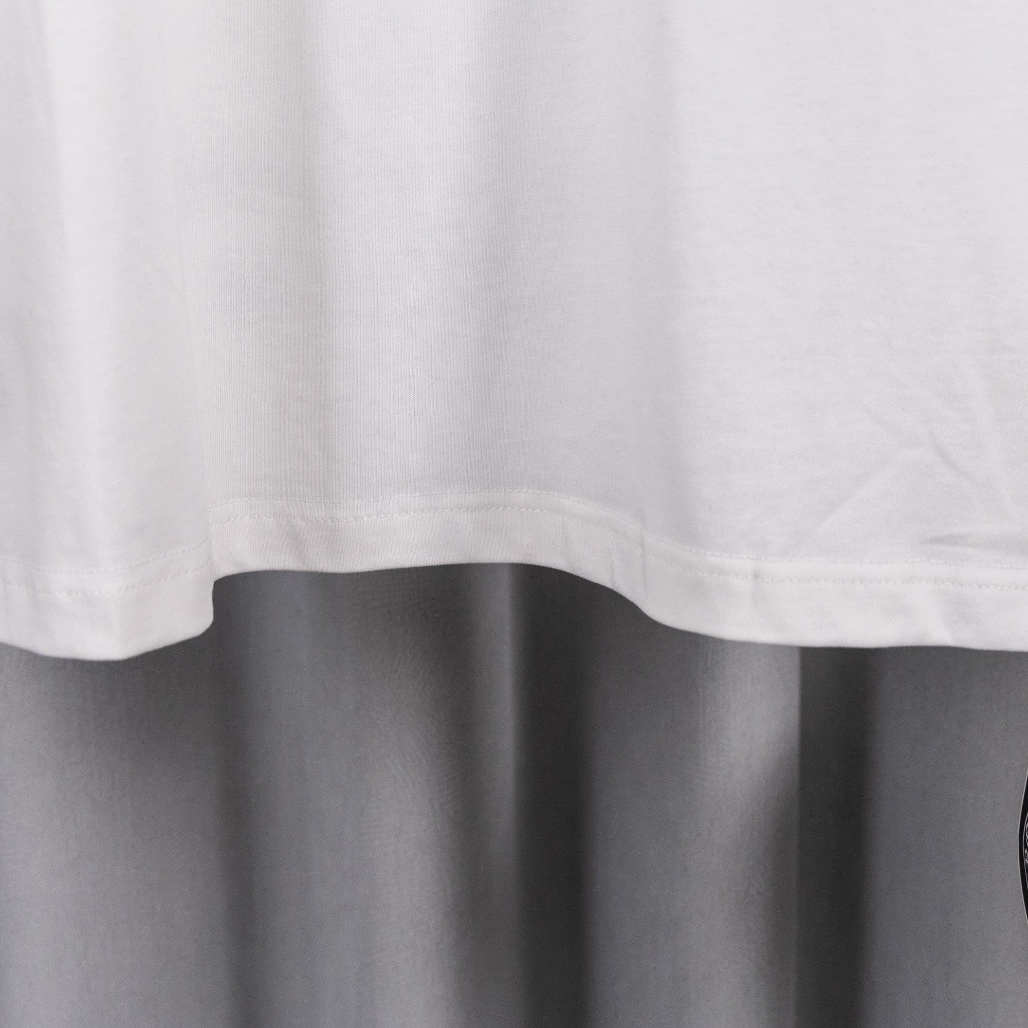 White short-sleeve shirt hem with slight curved drape