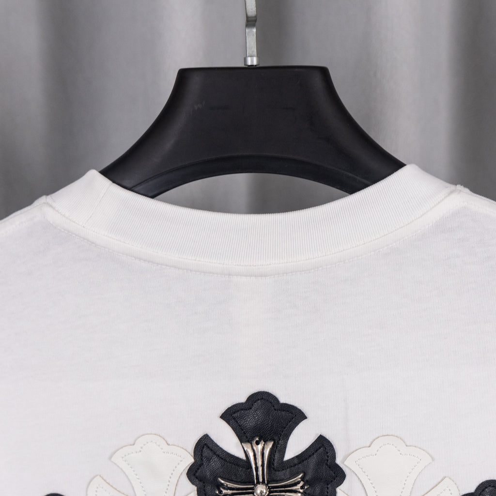 White short-sleeve shirt with black cross crest graphic at chest