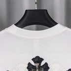 White short-sleeve shirt with black cross crest graphic at chest