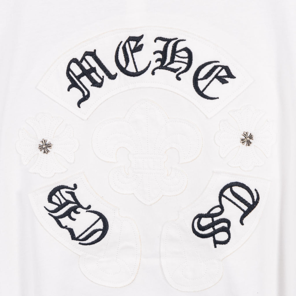 White T-shirt with dark decorative emblem panel and symbols