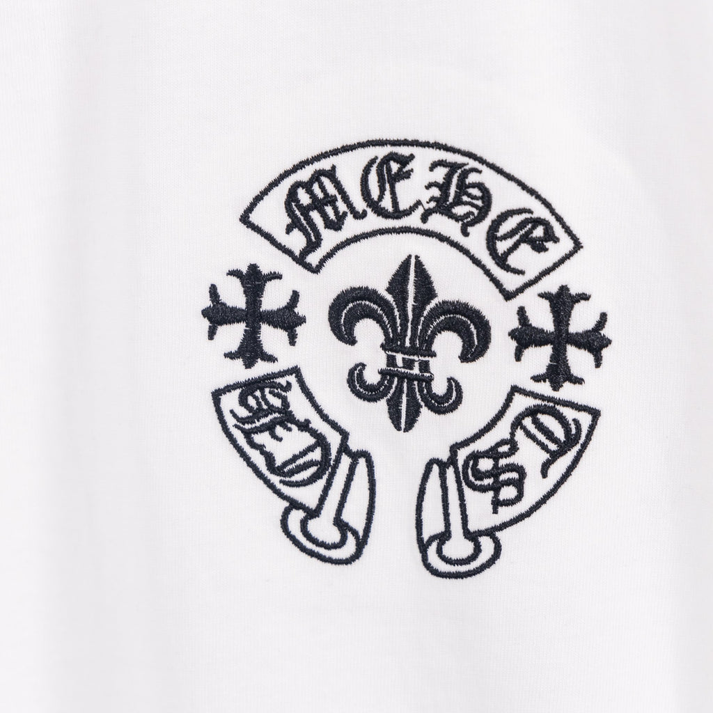 White T-shirt with dark circular fleur-de-lis emblem print