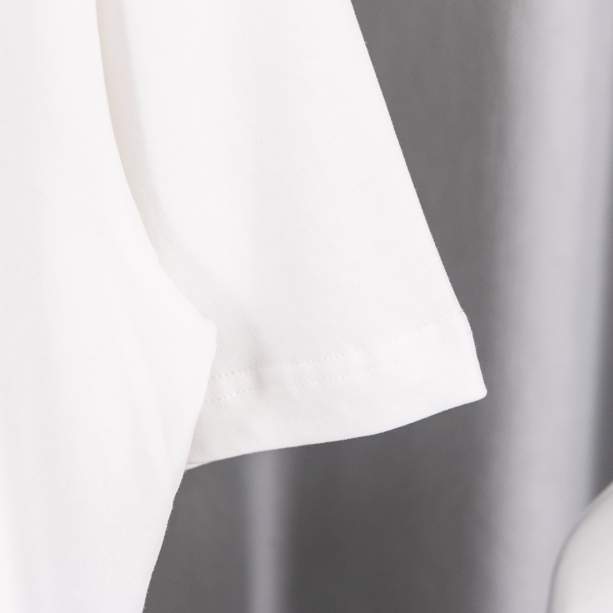 White short-sleeve T-shirt cuff with seam detail