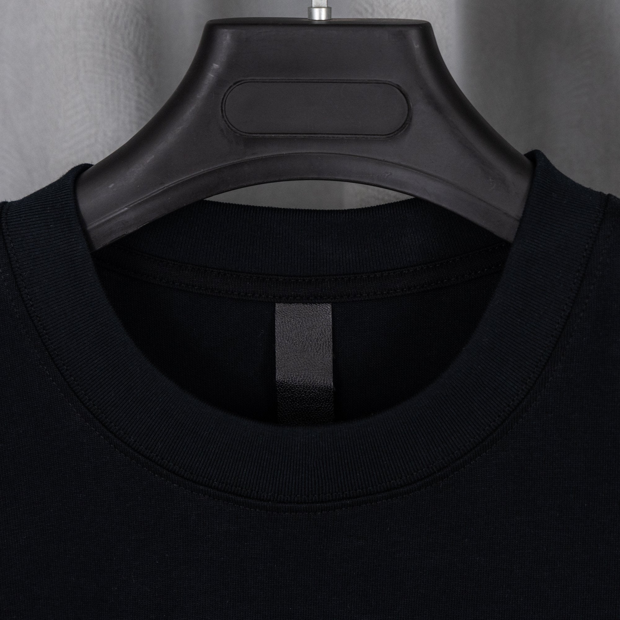 Black crewneck T-shirt neckline with black inner brand label