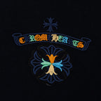 Black T-shirt chest logo detail with colorful ribbon and flower emblem