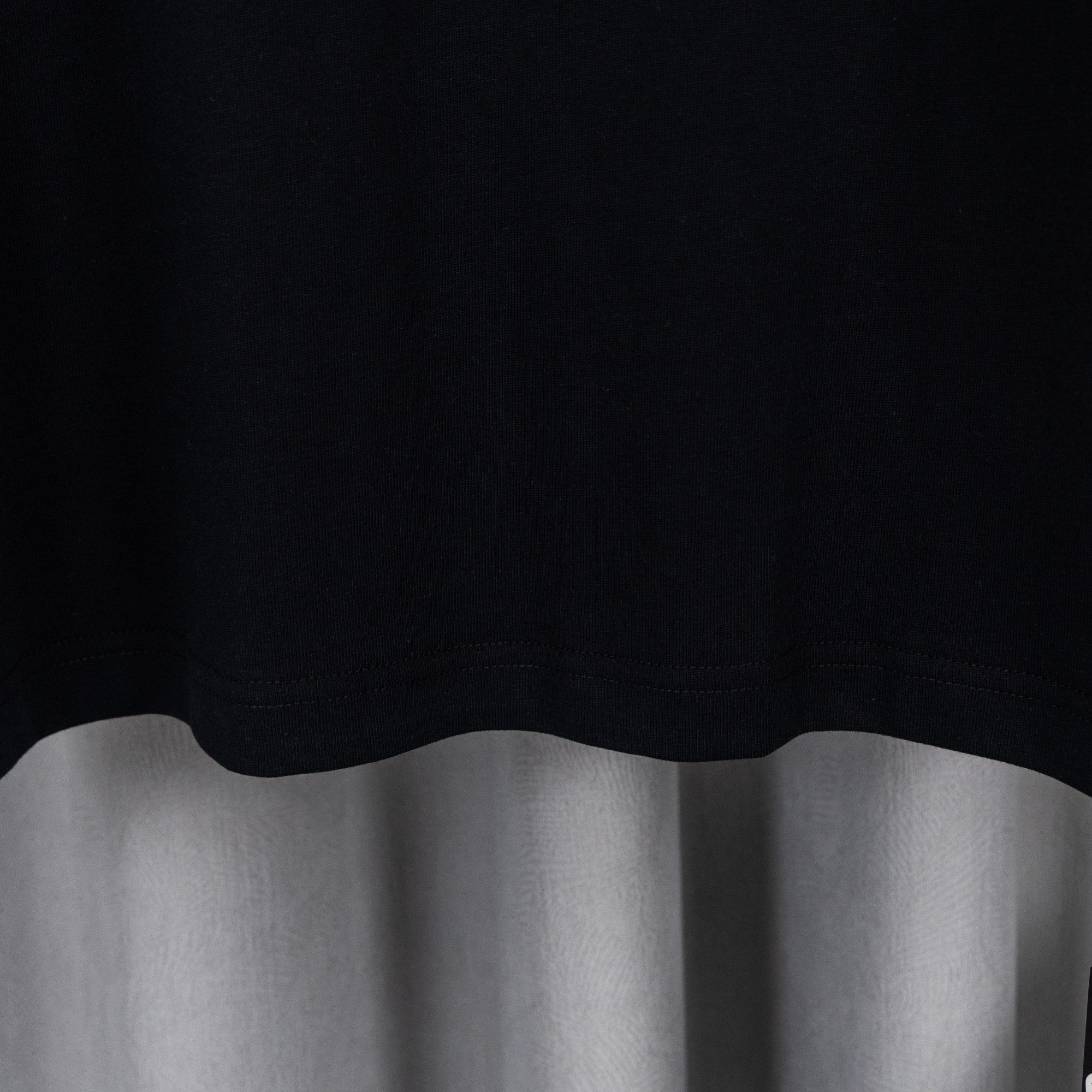 Black T-shirt hem with clean stitched edge