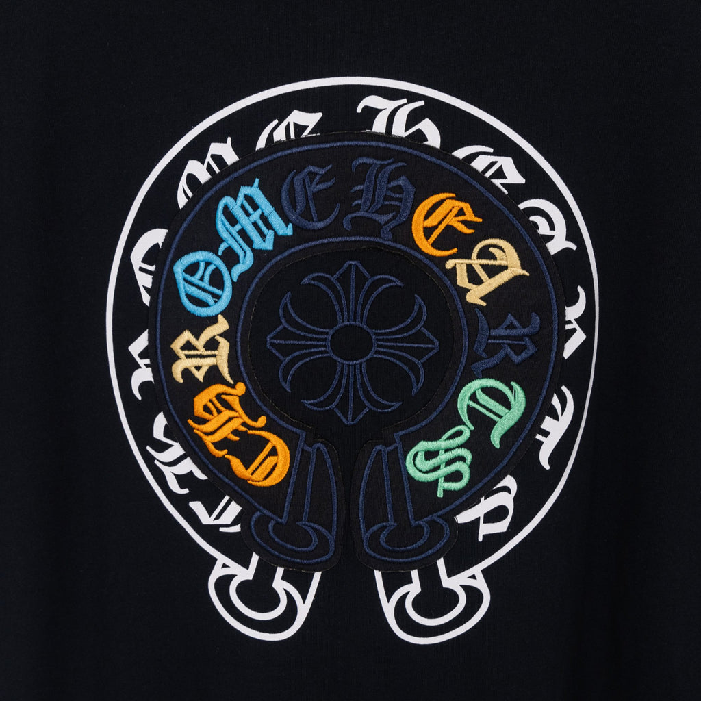 Black T-shirt close-up of large circular back graphic with colorful symbols
