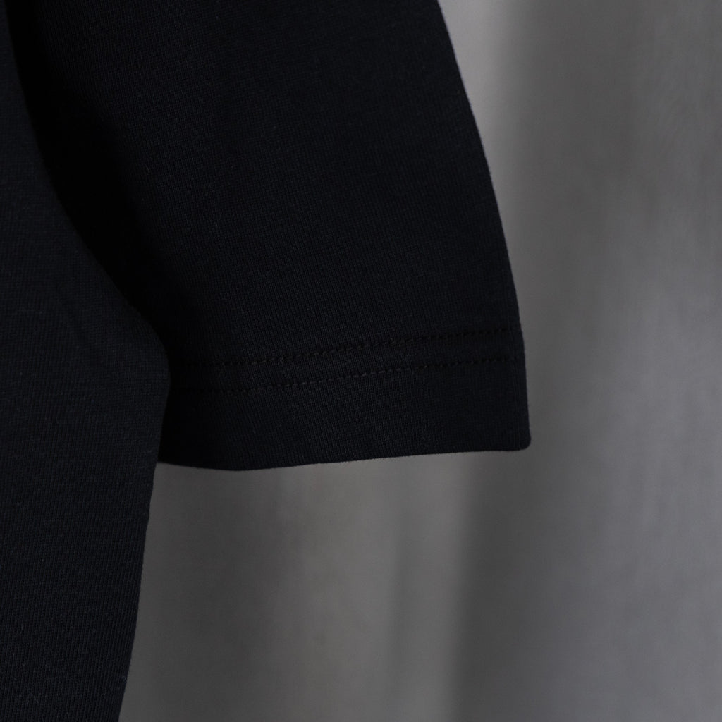 Black T-shirt hem with double-stitch seam detail