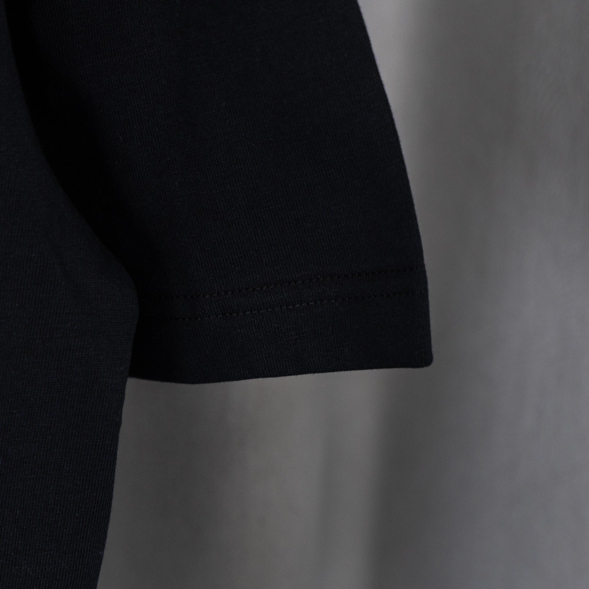 Black T-shirt hem with double-stitch seam detail