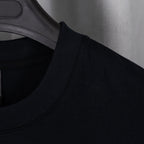 Black crew-neck T-shirt with ribbed collar on a hanger
