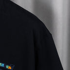 Black T-shirt sleeve with partial blue embroidered logo