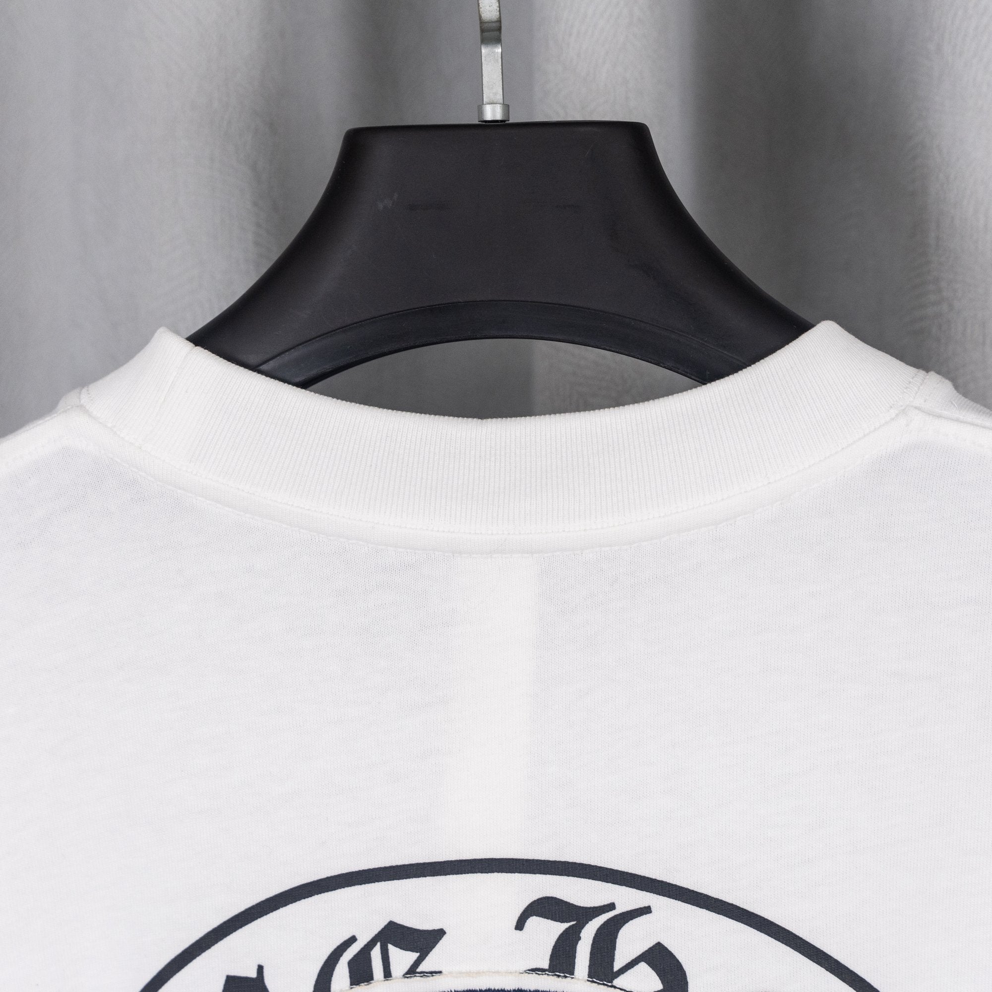 White T-shirt crew neckline ribbing with inside collar visible at back