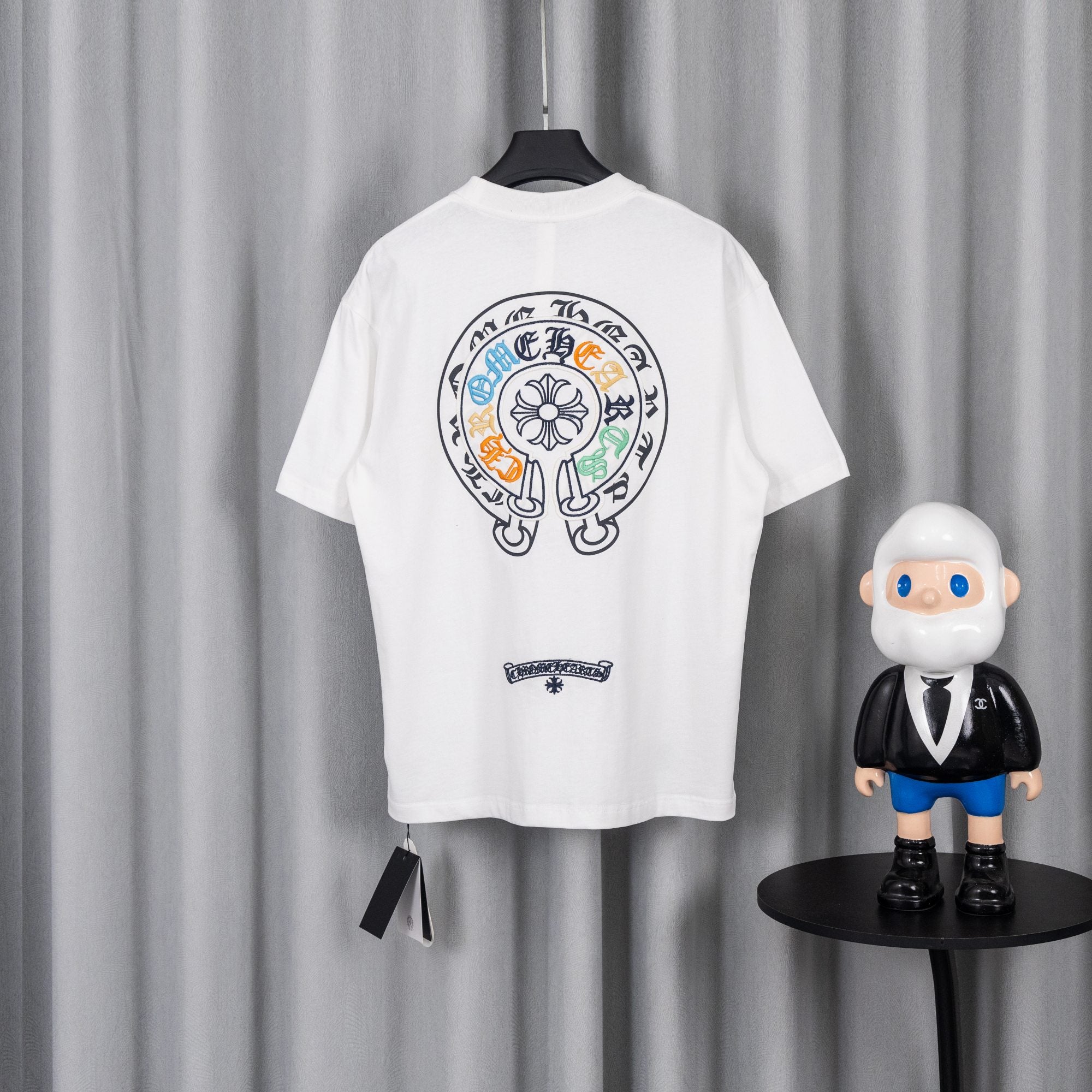 White short-sleeve T-shirt with large circular back crest and small chest patch