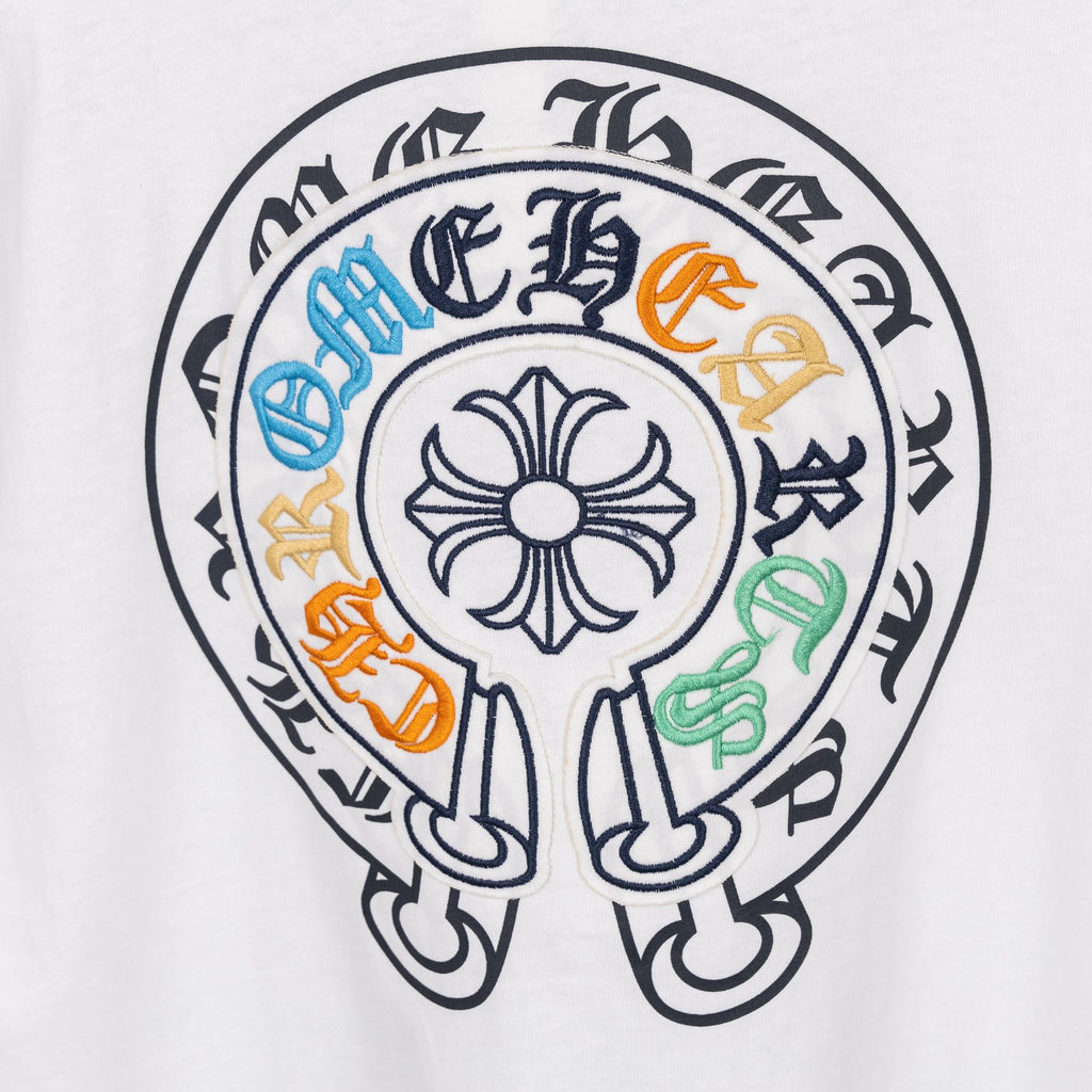 White T-shirt circular embroidered crest graphic with multicolor accents