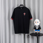 Black short-sleeve T-shirt with red trim cuffs and small chest graphic patch