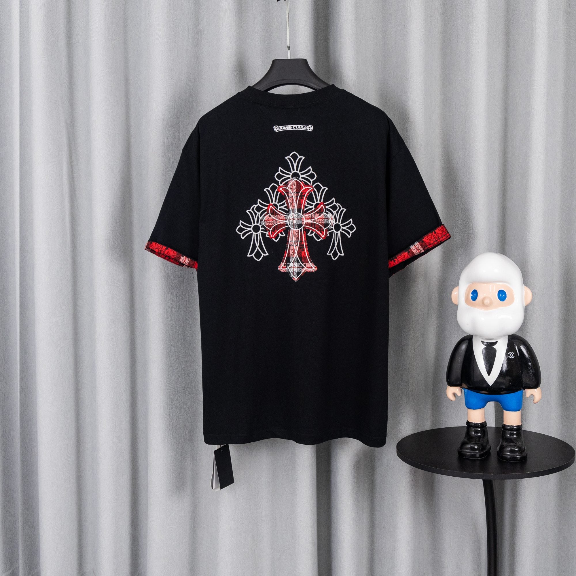 Black short-sleeve T-shirt with large back cross-style embroidery graphic and red trim