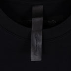 Black T-shirt neckline label near collar seam