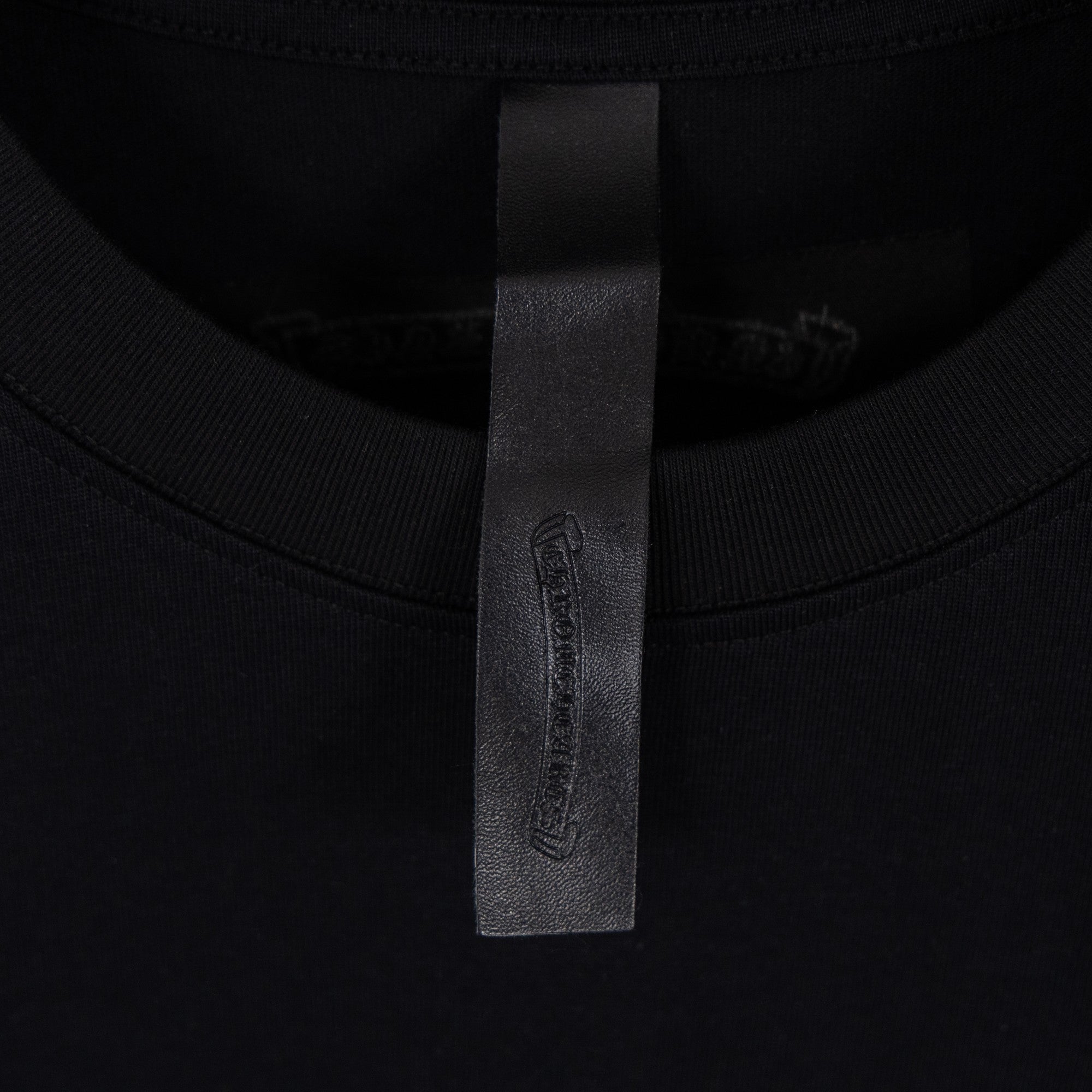 Black T-shirt neckline label near collar seam