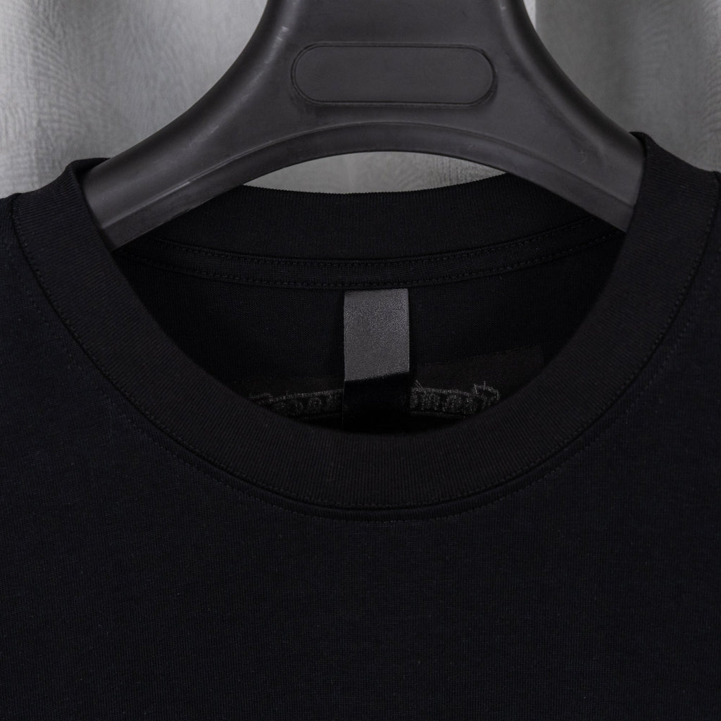 Black T-shirt collar and inner neck label view under hanger