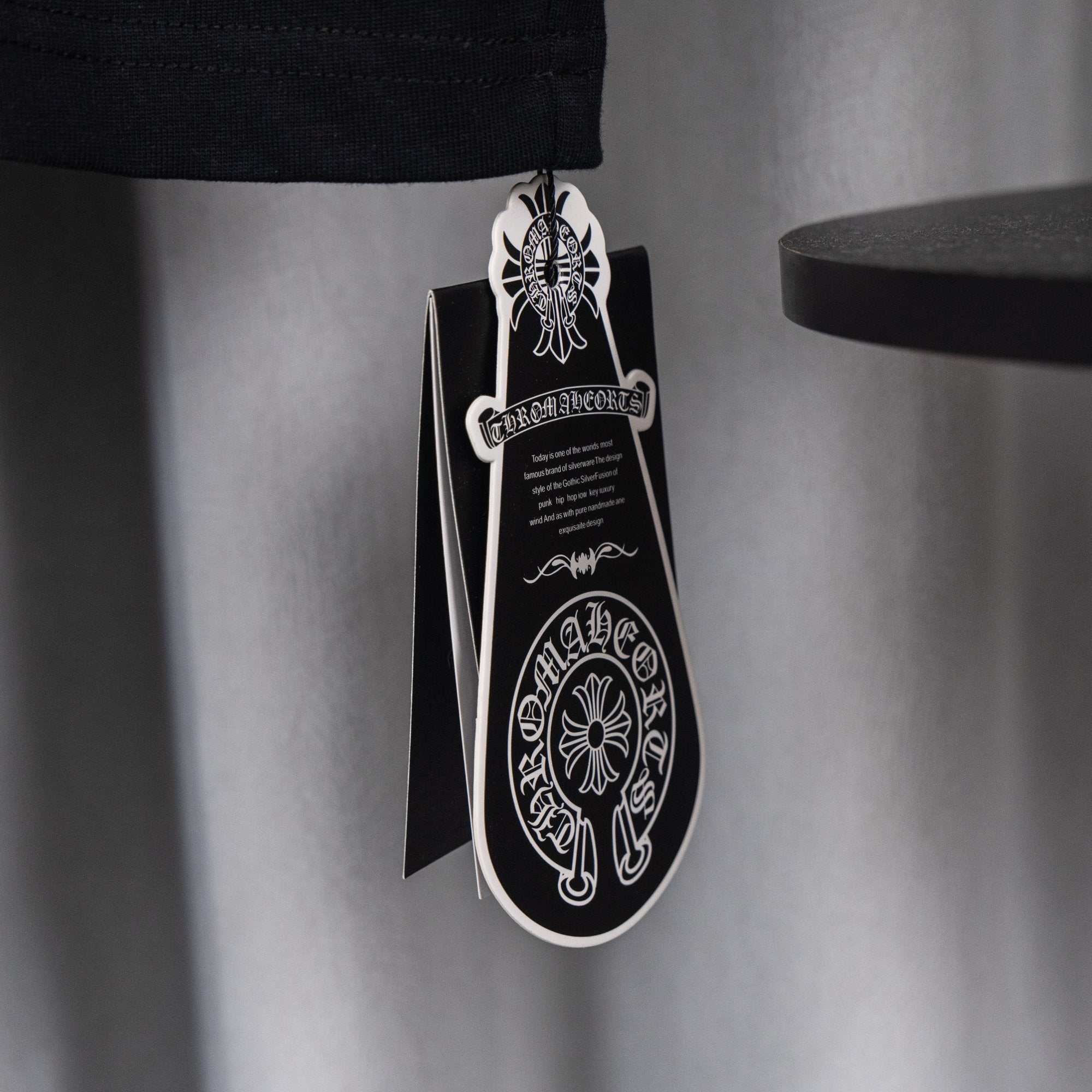 Black T-shirt with attached black retail hang tag