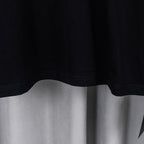 Black T-shirt lower hem with slight drape and clean stitched edge