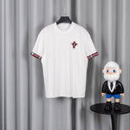 White crew-neck short-sleeve T-shirt with red plaid graphic on chest and sleeve trim