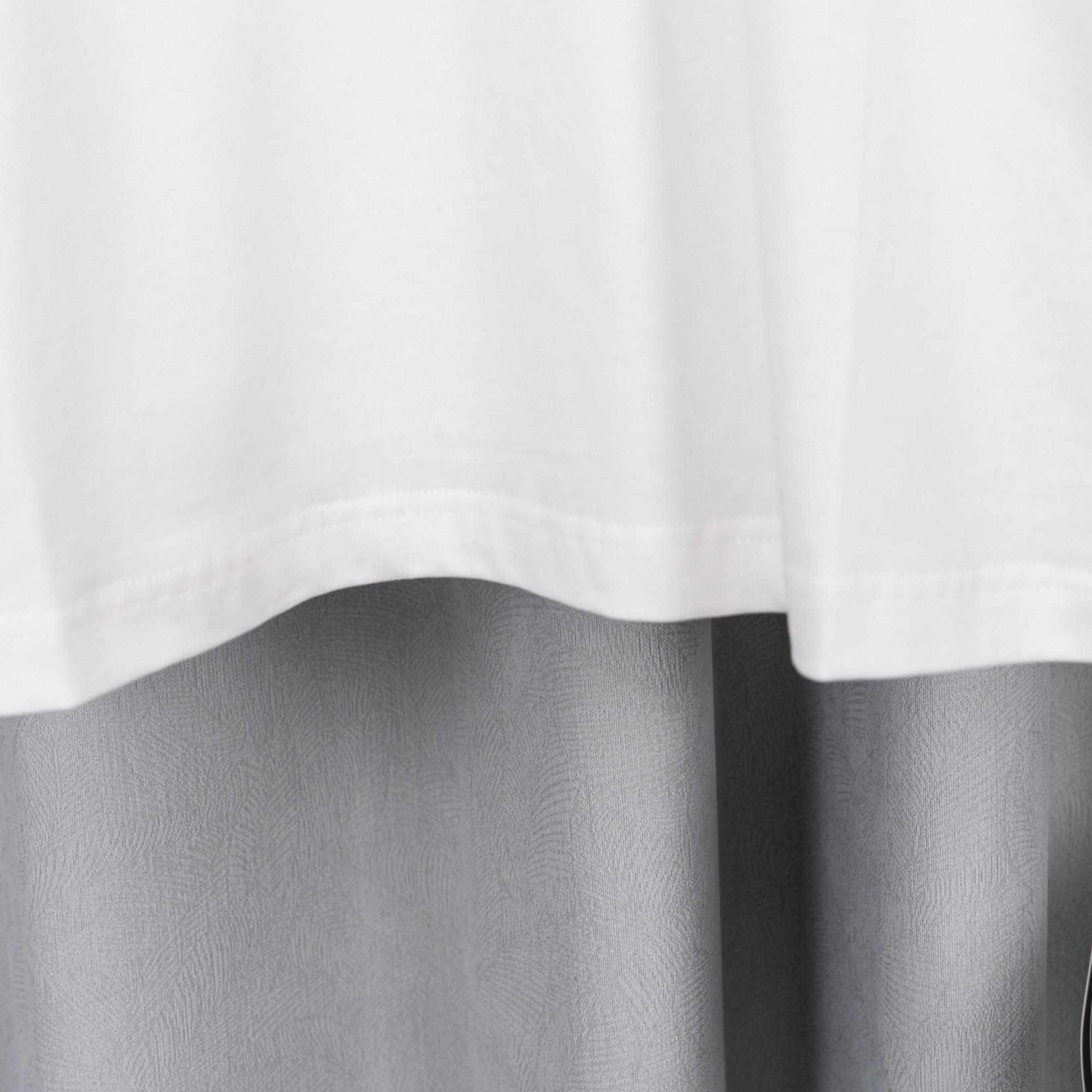 White short-sleeve T-shirt hem with subtle drape folds