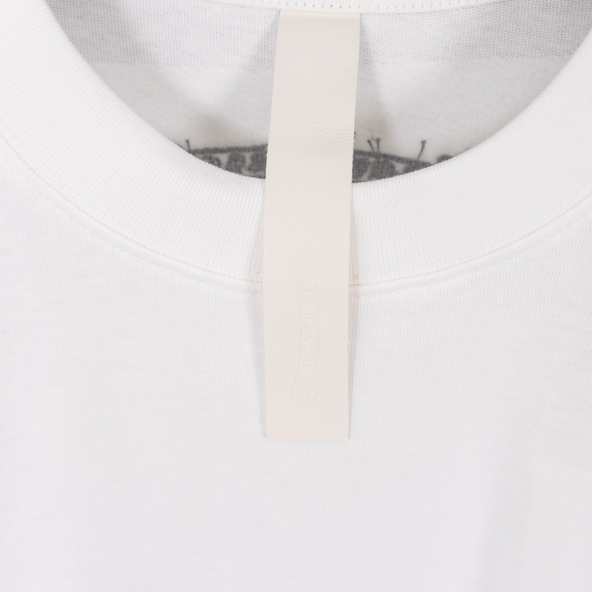 White crew-neck T-shirt neckline and inner neck tape detail