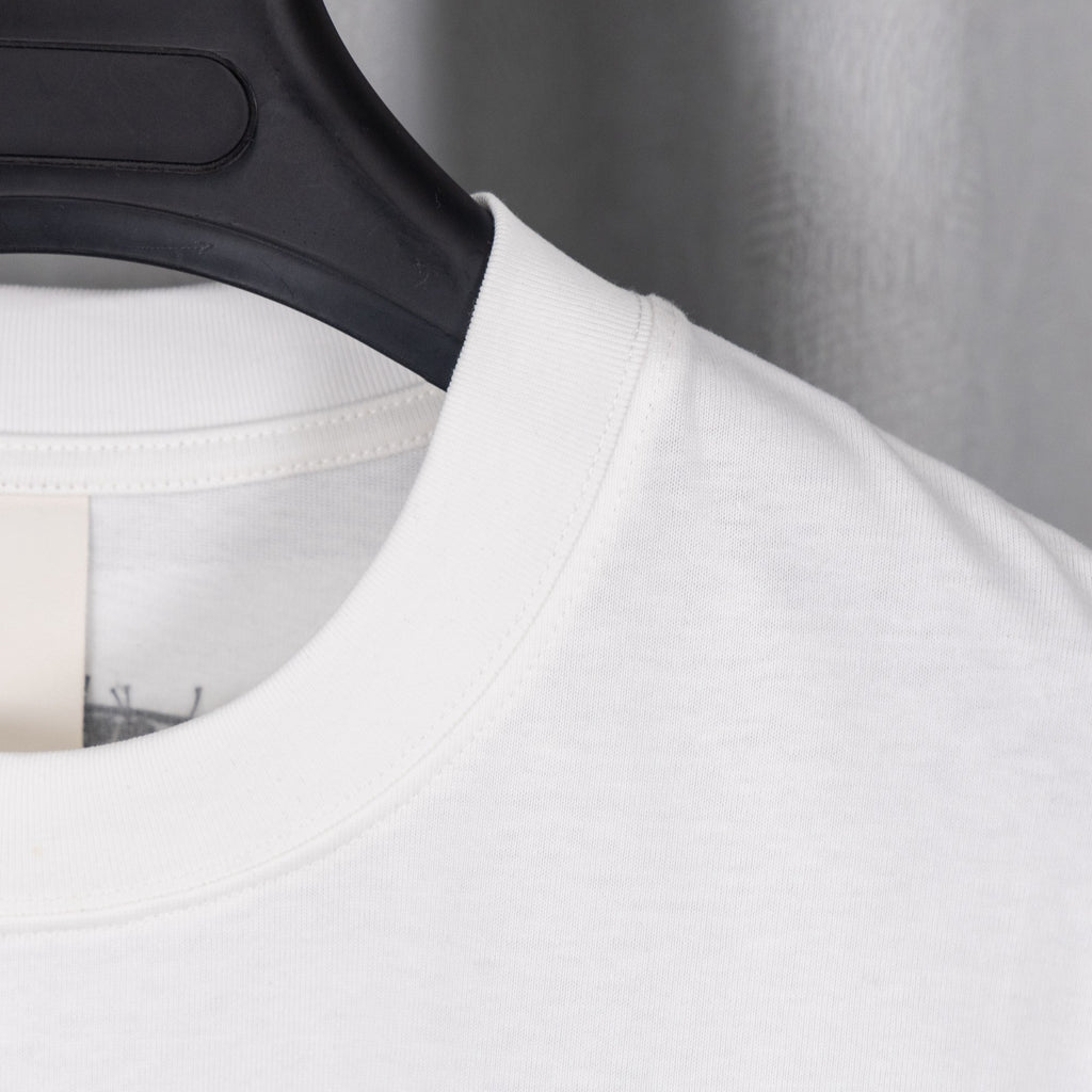 White T-shirt crew neck seam and curved graphic placement at upper chest