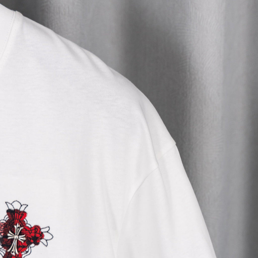 White shorts with small red and black embroidered crest