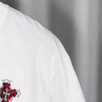White shorts with small red and black embroidered crest