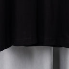 Black T-shirt bottom hem with visible stitching.