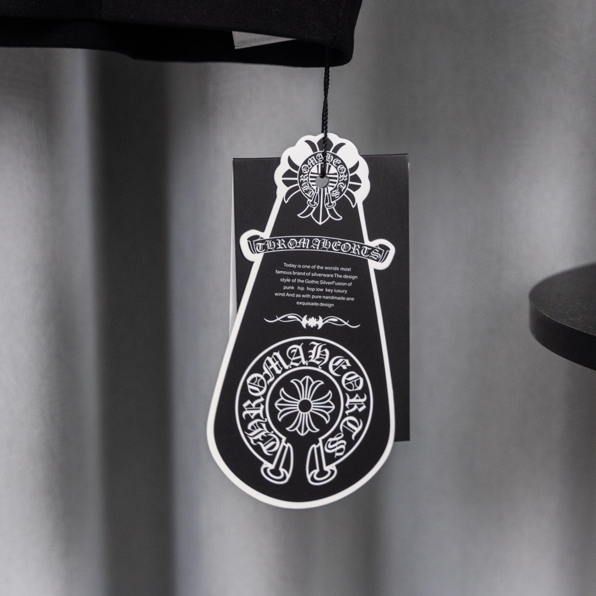 Black T-shirt with hanging white logo price tag