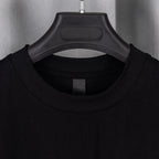 Black crewneck T-shirt with ribbed collar and short sleeves