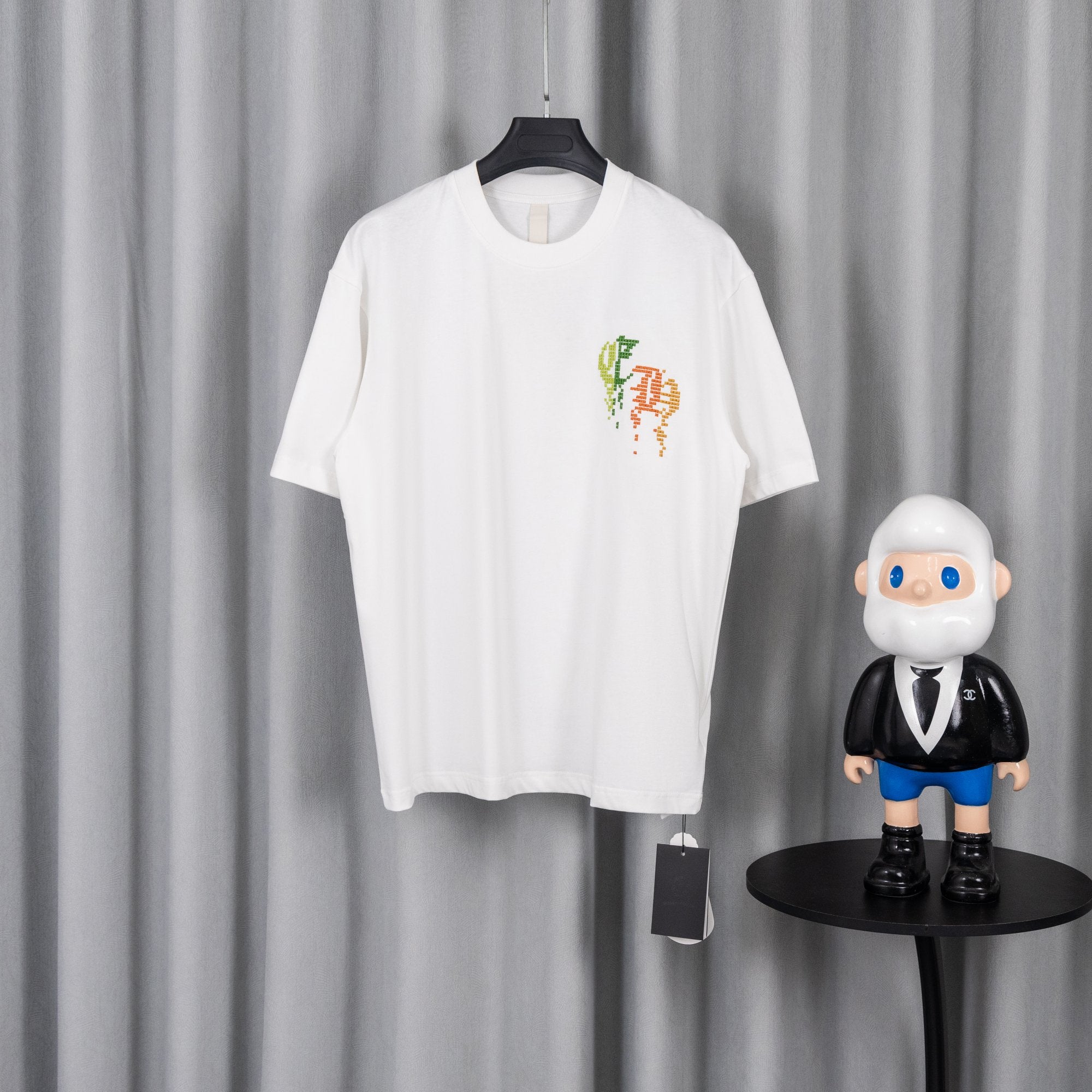 White crewneck short-sleeve T-shirt with colorful pixel-style logo on chest