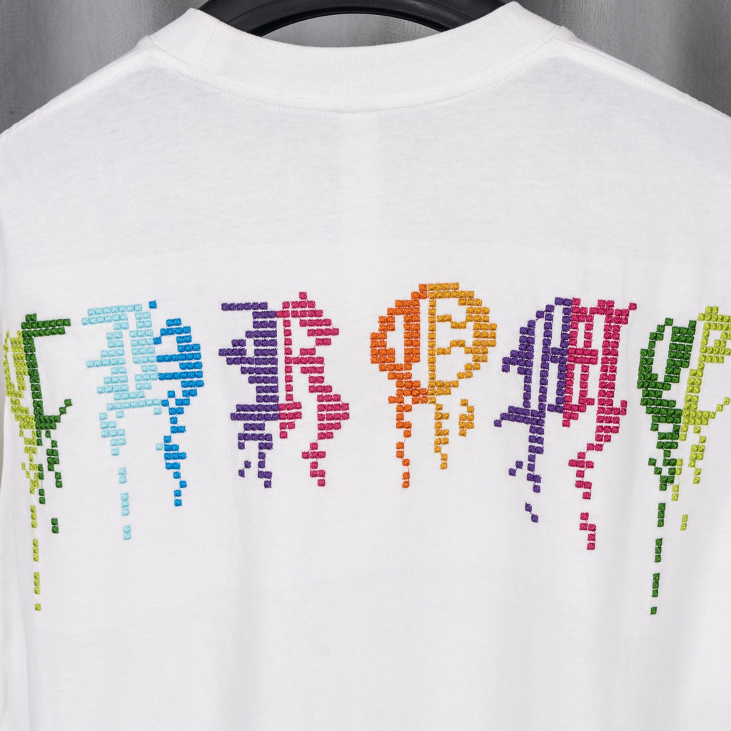 White T-shirt with colorful pixel-style letters across the upper back
