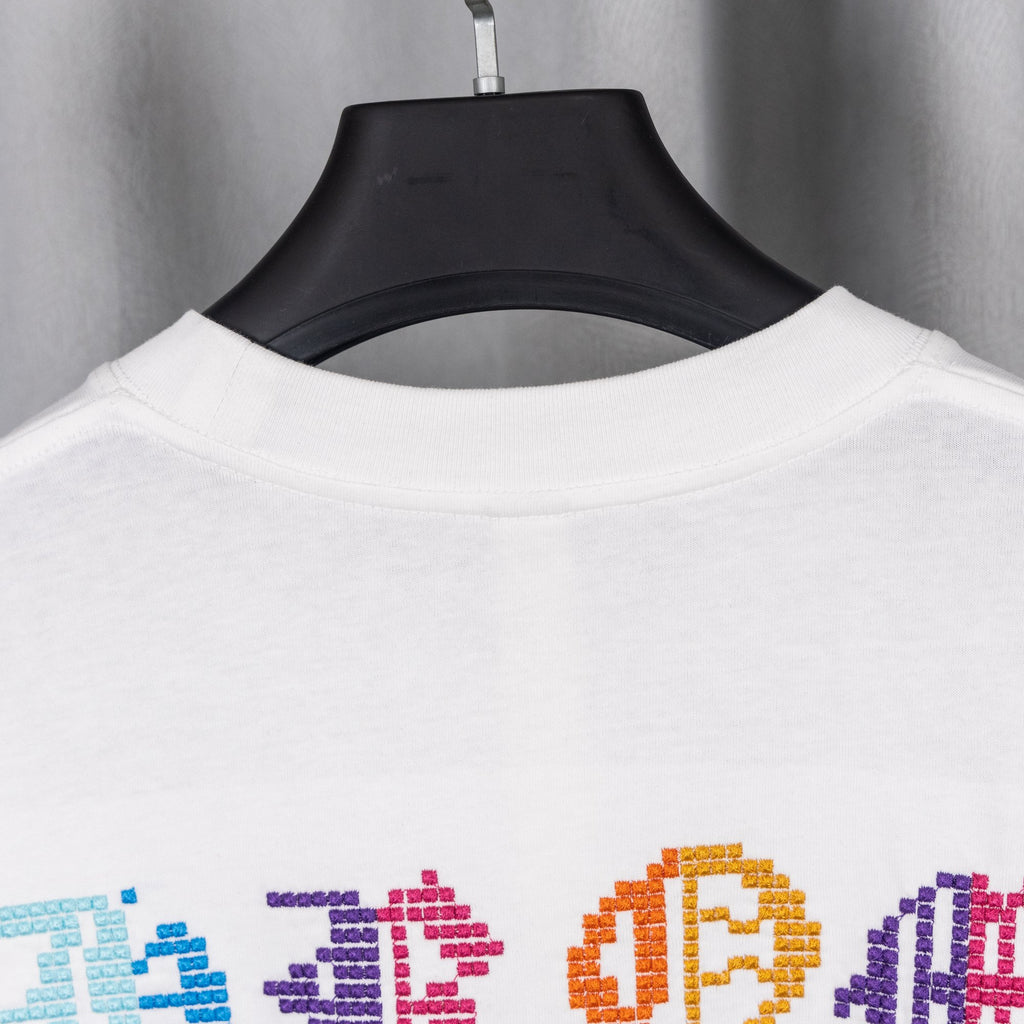White crewneck T-shirt back view with colorful pixel-style graphic near hem