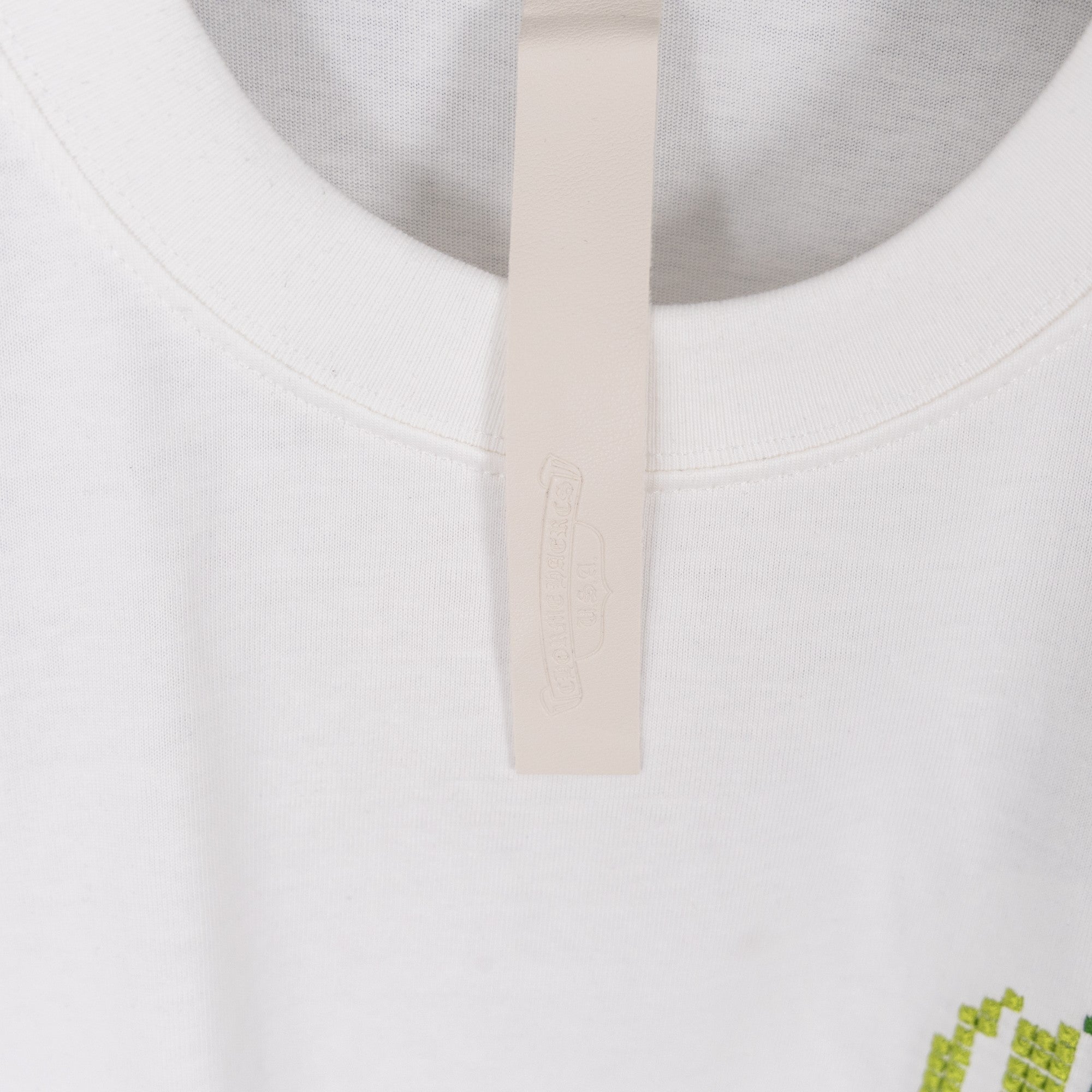 White crewneck T-shirt with plain neckline and hanging brand tag