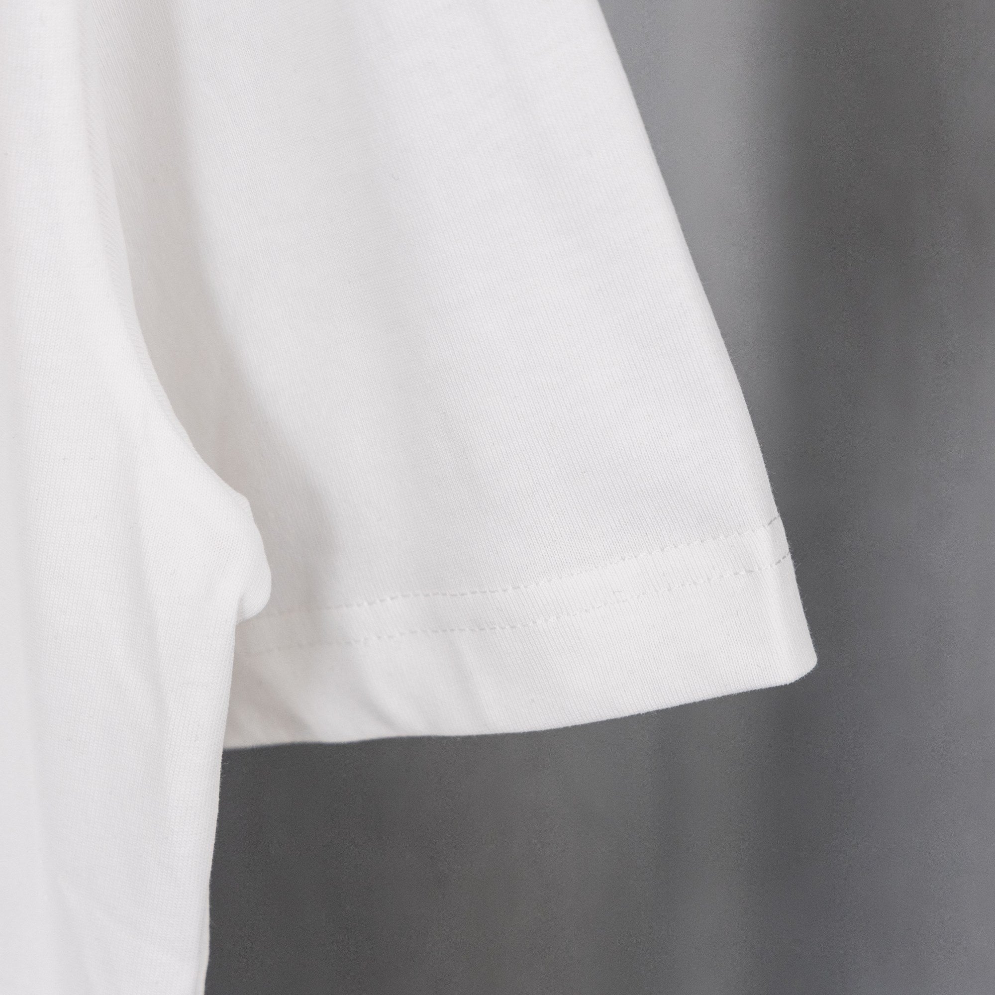 White short-sleeve T-shirt with curved hem and visible side seam