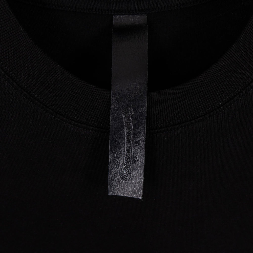 Black T-shirt neck label with fabric tag at inner collar