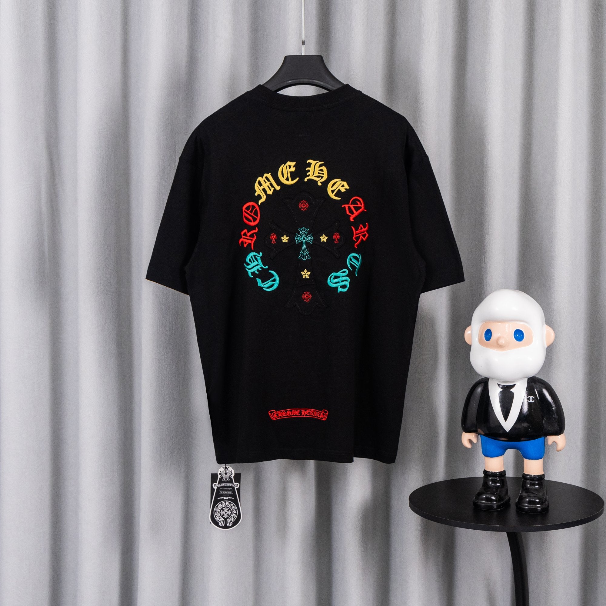 Black short-sleeve T-shirt with colorful circular cross graphic on back