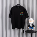 Black short-sleeve T-shirt with small colorful circular cross graphic on chest