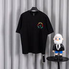 Black short-sleeve T-shirt with small colorful circular cross graphic on chest
