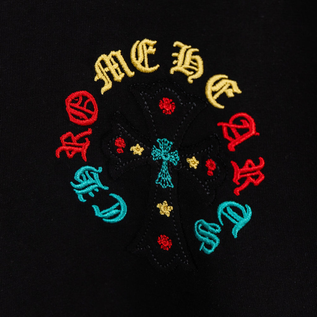 Black T-shirt close-up of multicolor circular cross graphic with small details