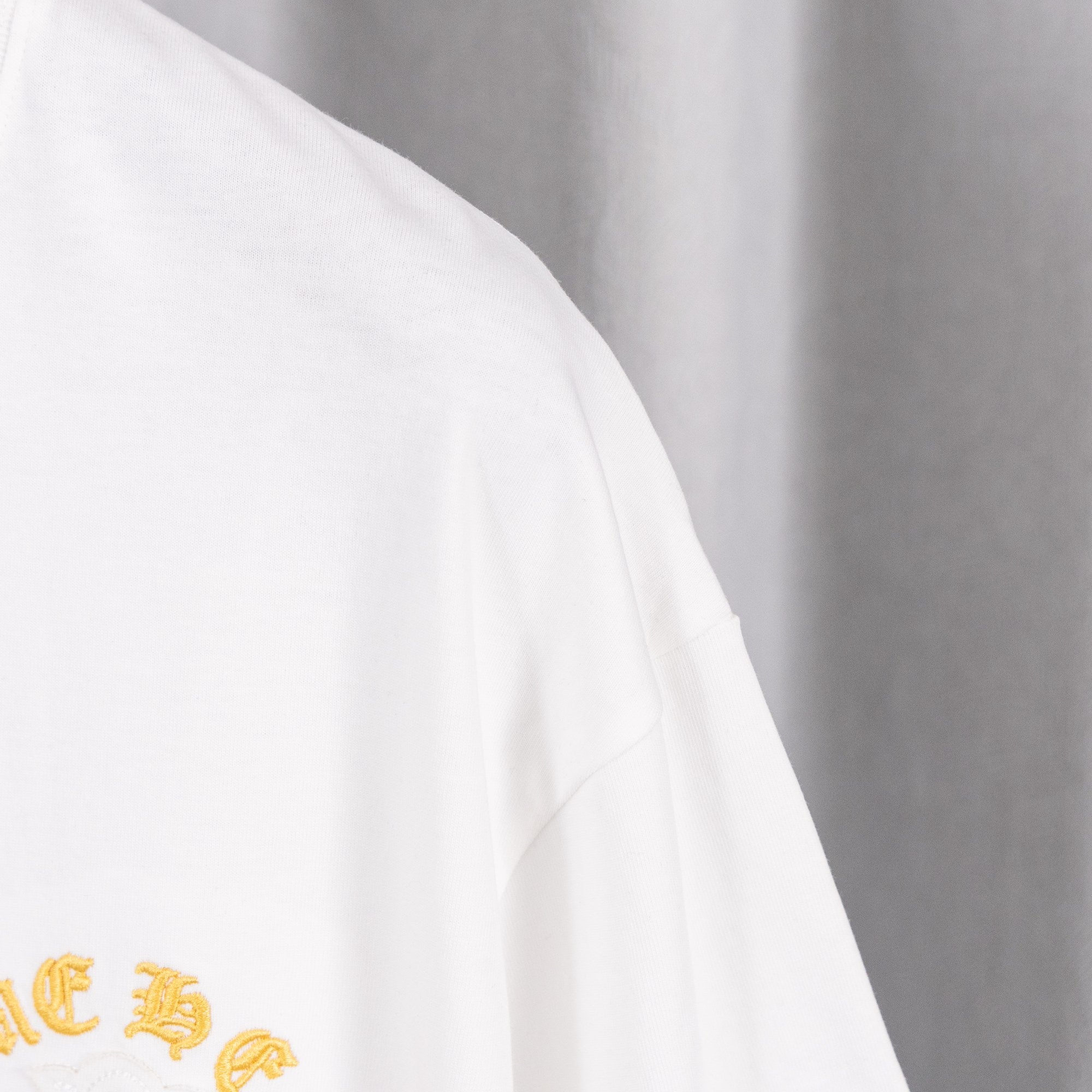 White short-sleeve T-shirt sleeve with smooth seam detail.