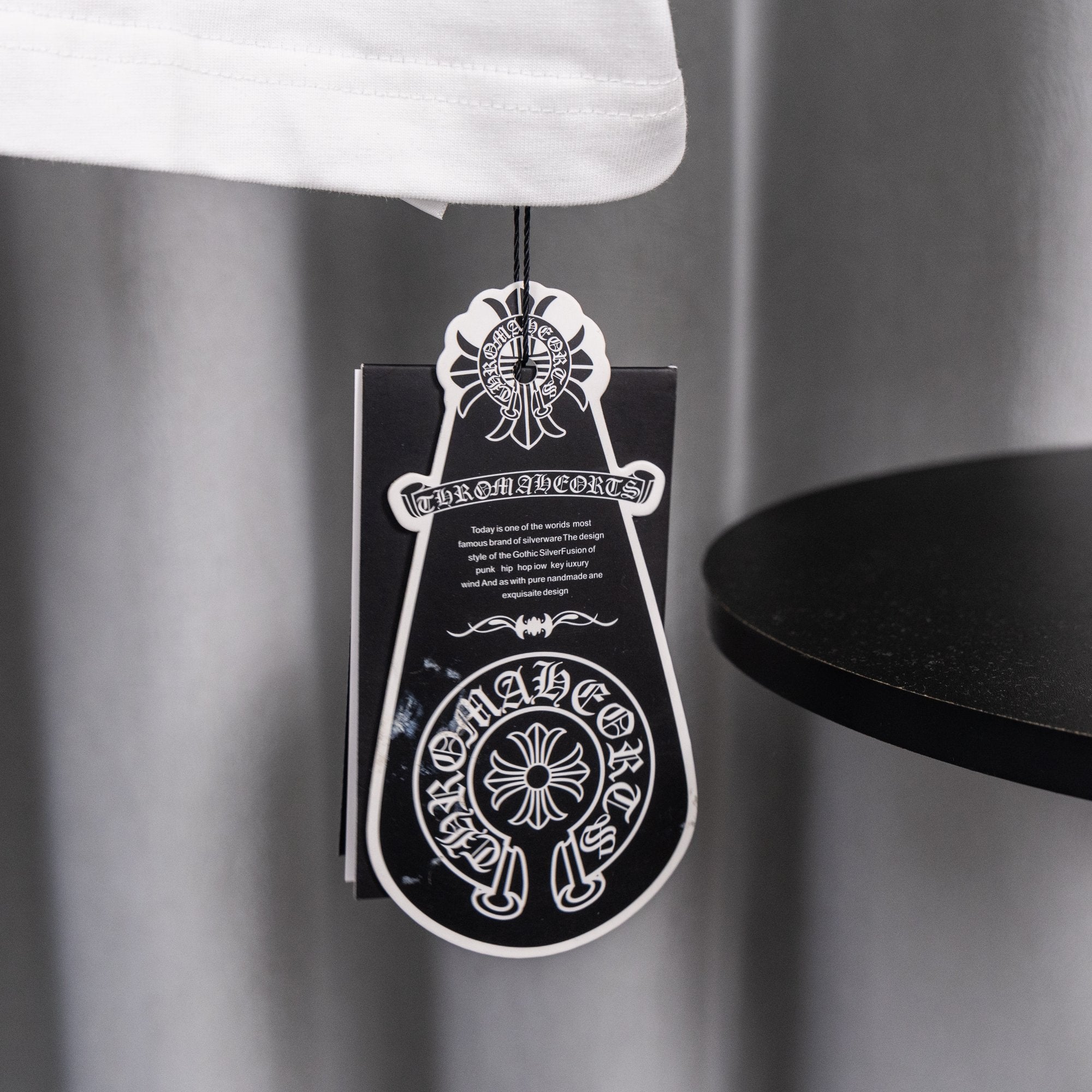 White short-sleeve T-shirt with black and white hanging tag
