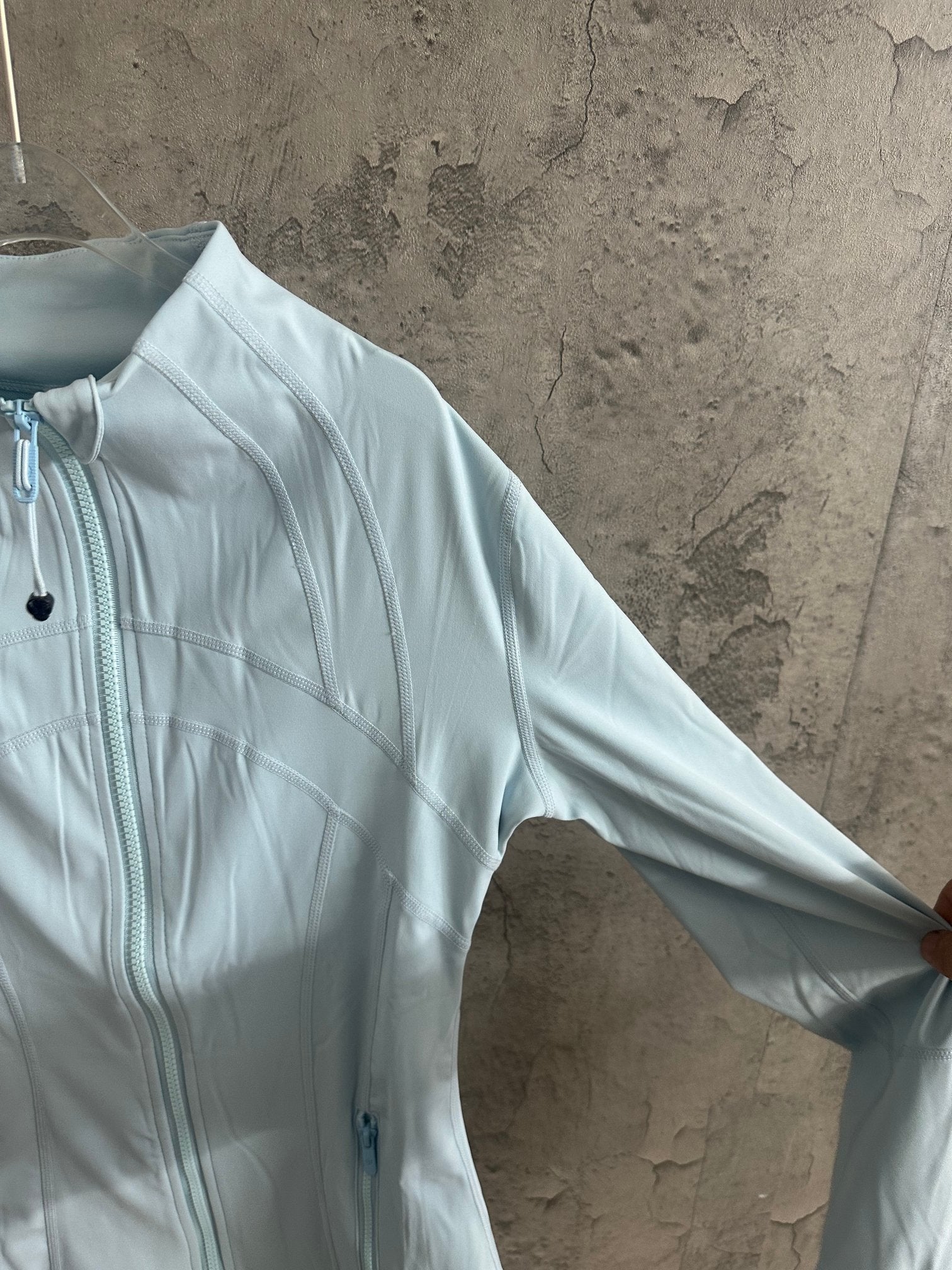 Ralph Lauren light blue zip-up jacket sleeve with center-front zipper detail